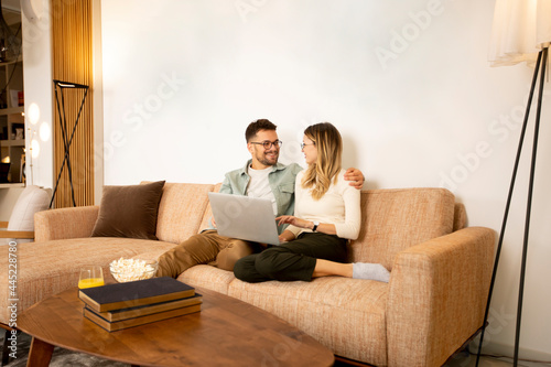 Young couple using laptop t...
