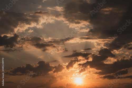 Fototapeta Naklejka Na Ścianę i Meble -  Natural background: sun and clouds are reflected in the water at sunset in summer