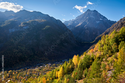 The village of Les Claux in Vallouise Valley with Mont Pelvoux (Ecrins National Park massif) in the distance in Autumn. Hautes-Alpes, Southern French Alps, France
