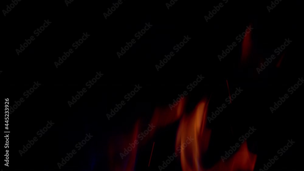 Flames burning effect background. Particles over black background.
