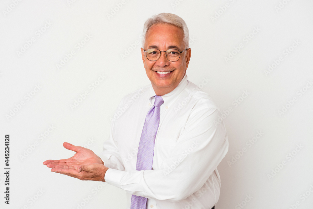 Senior american man isolated on white background holding a copy space on a palm. Senior american man isolated on white background holding a copy space on a palm.