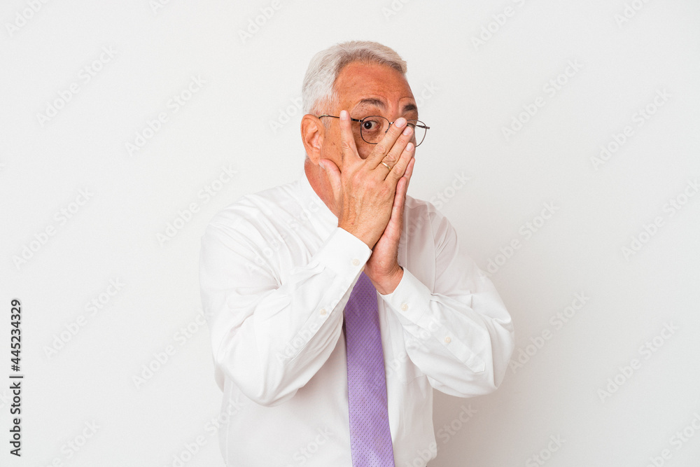 Senior american man isolated on white background blink through fingers frightened and nervous.