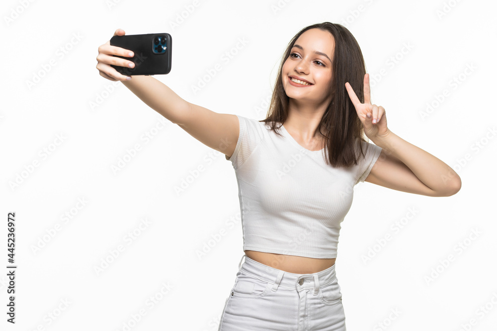 Beautiful young woman is making selfie photo with smartphone. Beautiful young woman is making selfie photo with smartphone.