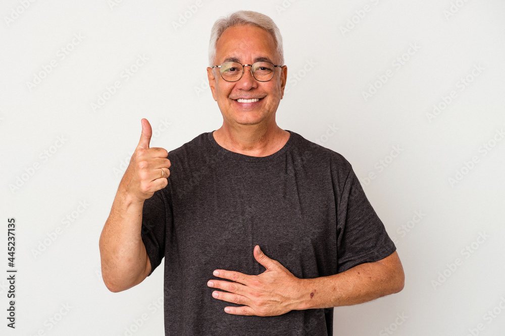 Senior american man isolated on white background touches tummy, smiles gently, eating and satisfaction concept. Senior american man isolated on white background touches tummy, smiles gently, eating and satisfaction concept.