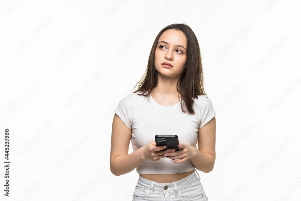 Portrait of a smiling woman holding smartphone over white background Portrait of a smiling woman holding smartphone over white background
