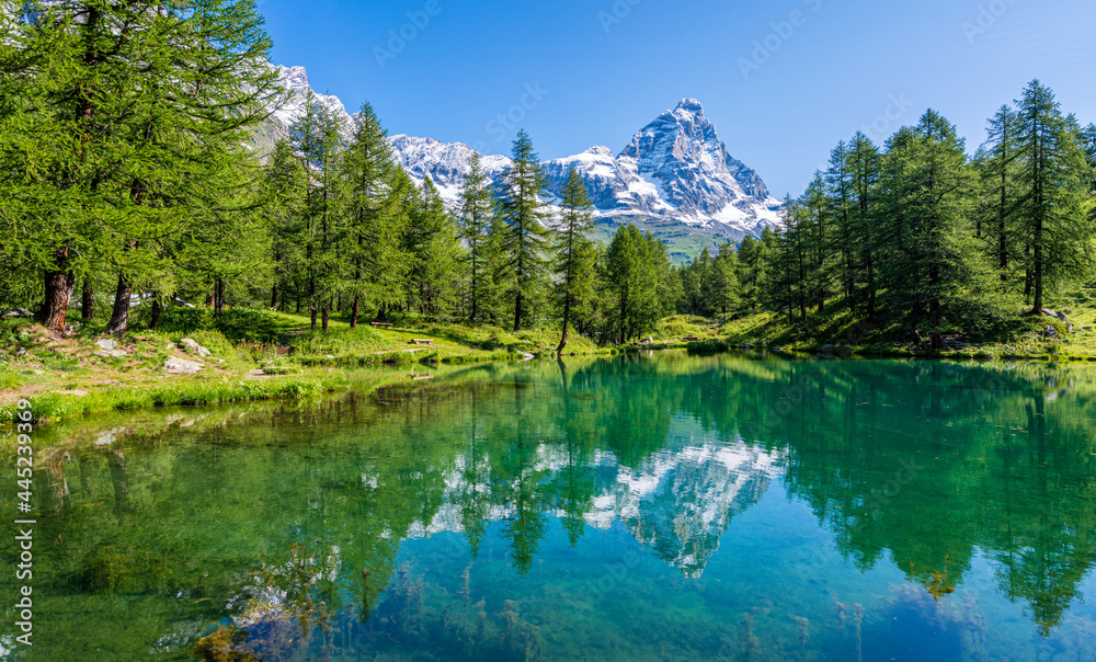 Idyllic morning view at the Blue Lake with the Matterhorn reflecting on the water, Valtournenche, Aosta Valley, Italy.
