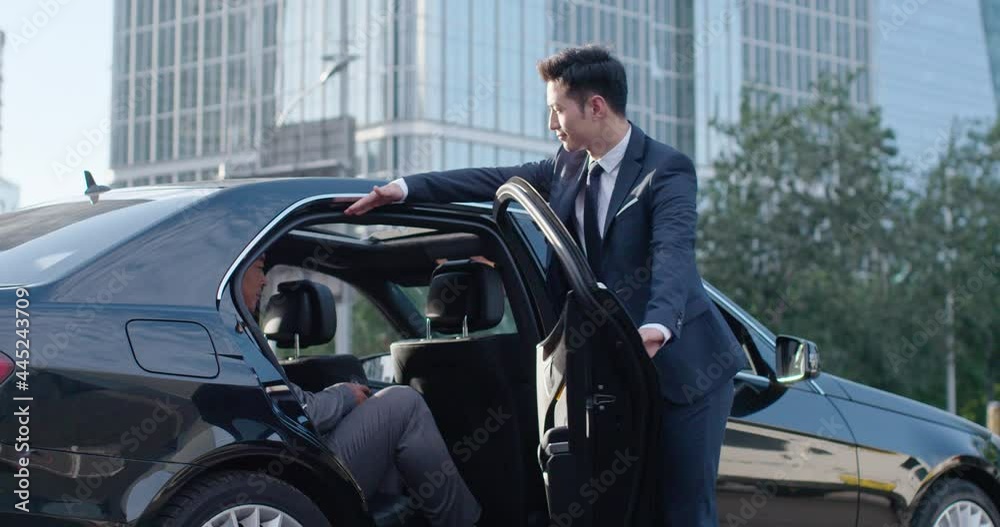 Confident businessman getting out of car,4K