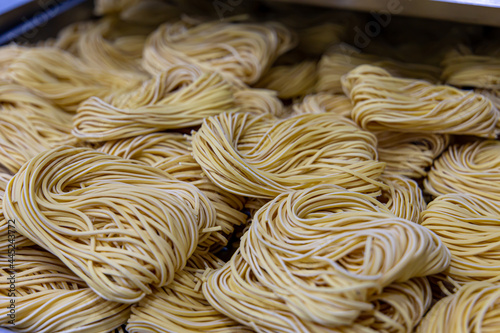 Artisan production of noodles in an Italian restaurant. Yellow noodles in the drying process