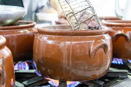 Ceramic pot with feijoada  typical Brazilian food. In a restaurant in Brazil