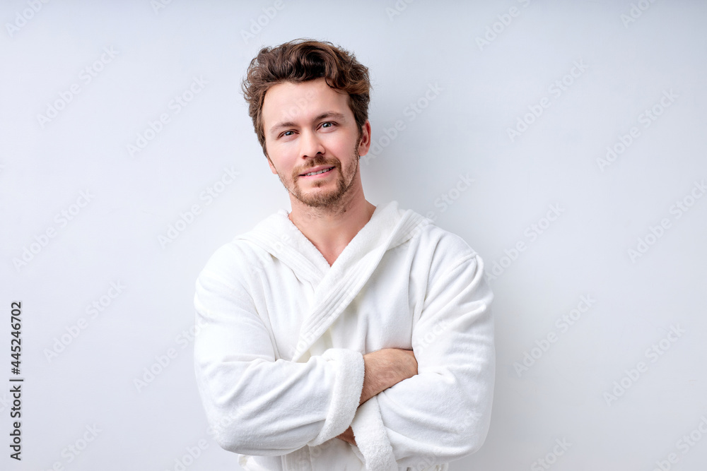 Handsome man wearing bathrobe smiling, posing with arms folded, isolated on white, Portrait of caucasian guy in the morning, enjoy weekends, look at camera having nice smile. People lifestyle concept Handsome man wearing bathrobe smiling, posing with arms folded, isolated on white, Portrait of caucasian guy in the morning, enjoy weekends, look at camera having nice smile. People lifestyle concept