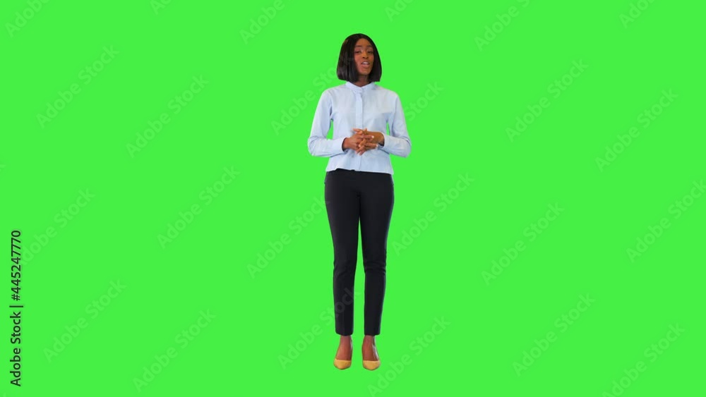 Young black businesswoman presenting advertising product or service speak confident, point finger up on a Green Screen, Chroma Key.