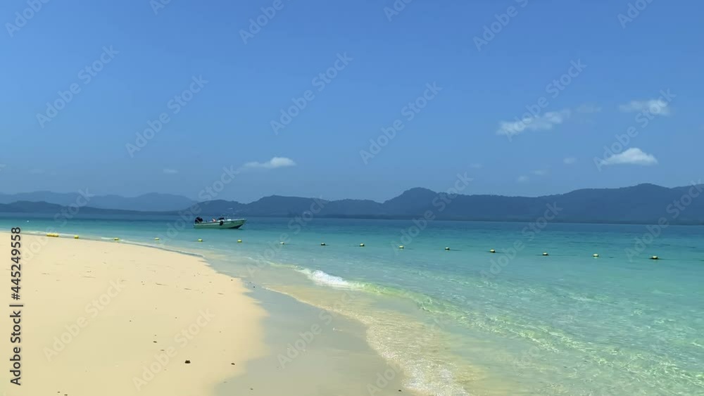 beach with buoys and motor boat. concept clear sky and island. blue clear water, shore sand. beach with buoys and motor boat. concept clear sky and island. blue clear water, shore sand.