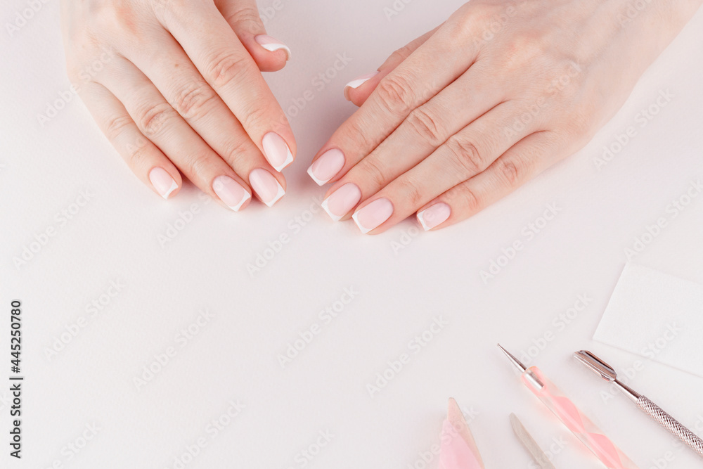 Feminine hands with trendy clean French manicure