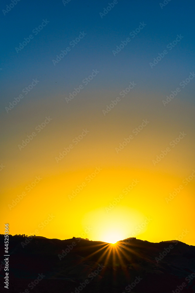 Sunset over the horizon with Sunburst, sun star