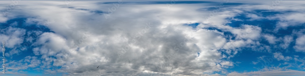 Fototapeta premium Blue evening sky seamless panorama spherical equirectangular 360 degree view with Cumulus clouds, setting sun. Full zenith for use in 3D graphics, game and aerial drone panoramas as sky replacement.
