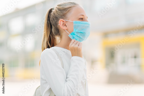 Little schoolgirl in a mask during an outbreak of coronavirus and influenza virus, Protection from diseases for children