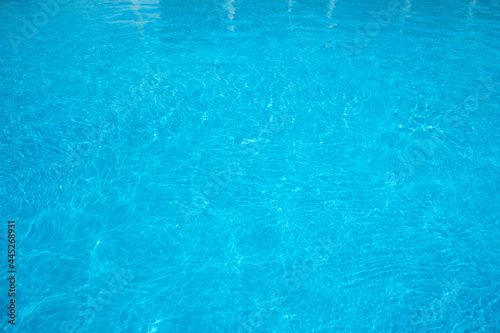 blue water surface in the swimming pool, water in the pool. horizontal background for summer concept.