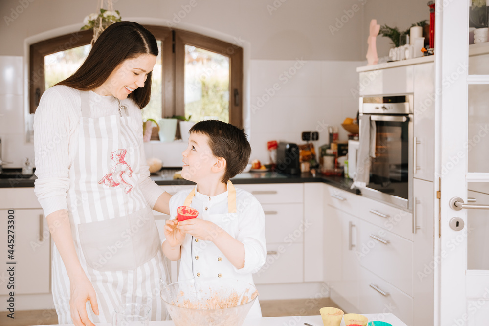 mother and child cooking. Mother and child bake muffins together mother and child cooking. Mother and child bake muffins together