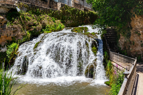 Waterfalls from the Cifuentes river as it passes through the town of Trillo. Wild river. Urban waterfalls.