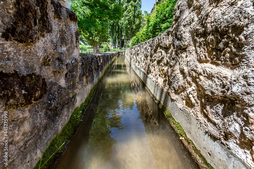 Medieval stone water channels as they pass through the city of Trillo in Guadalajara. Irrigation channels. Urban waterways.