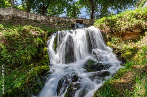 Waterfalls from the Cifuentes river as it passes through the town of Trillo. Wild river. Urban waterfalls.