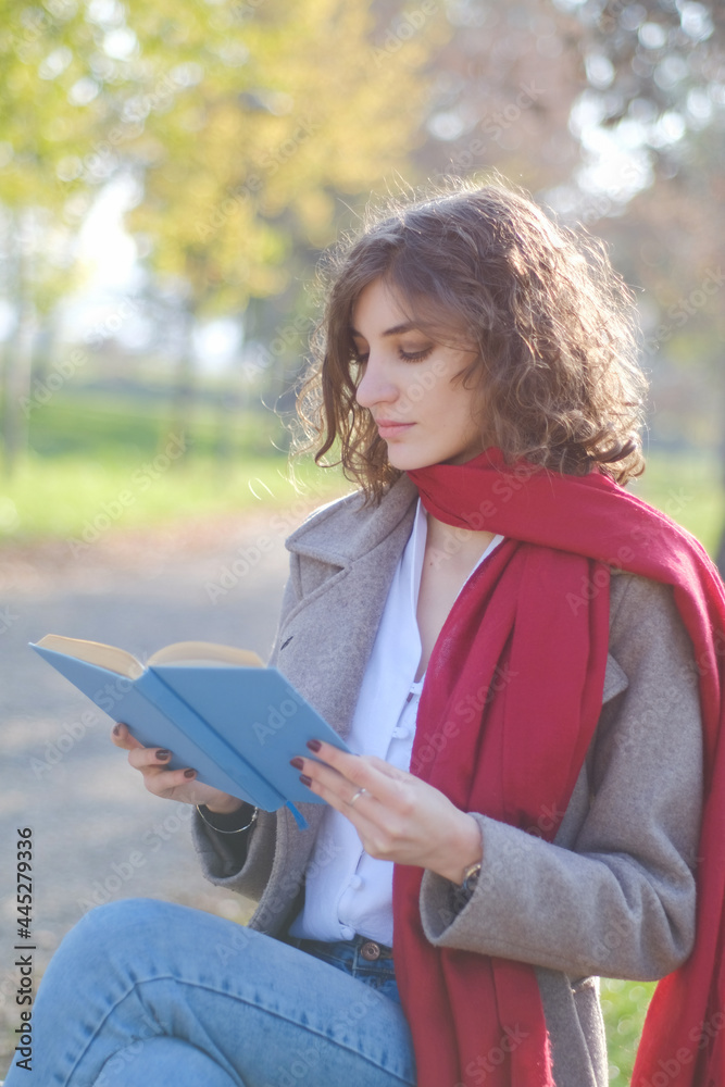 Portrait of a woman reading a book in the park Portrait of a woman reading a book in the park