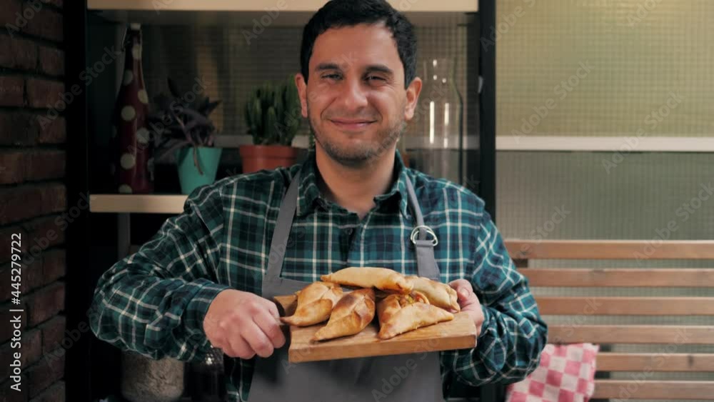 Man cooking empanadas argetinian pie, traditional bakery from argentina, chef filling dough in home with meat and vegetables, homemade spanish empanadas Man cooking empanadas argetinian pie, traditional bakery from argentina, chef filling dough in home with meat and vegetables, homemade spanish empanadas