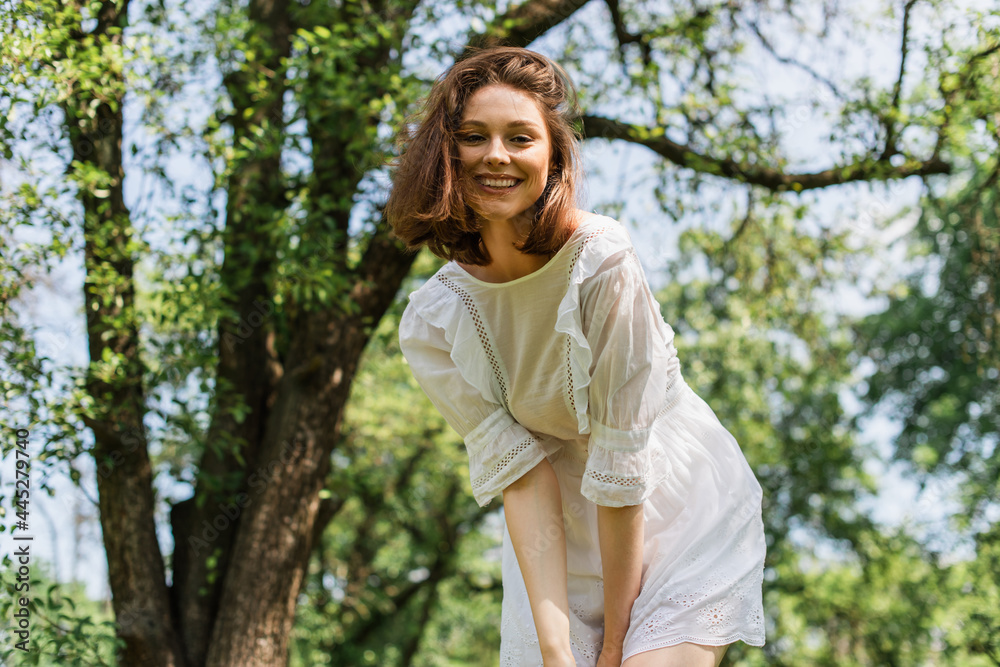 Pretty woman looking at camera in park during summer Pretty woman looking at camera in park during summer