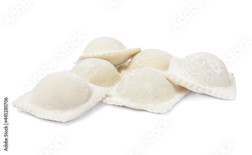 Uncooked ravioli with filling on white background