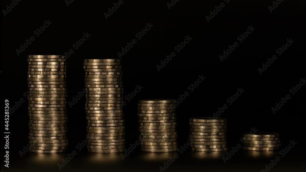 4K Stop motion shows the stack of five piles of gold cash coins ...