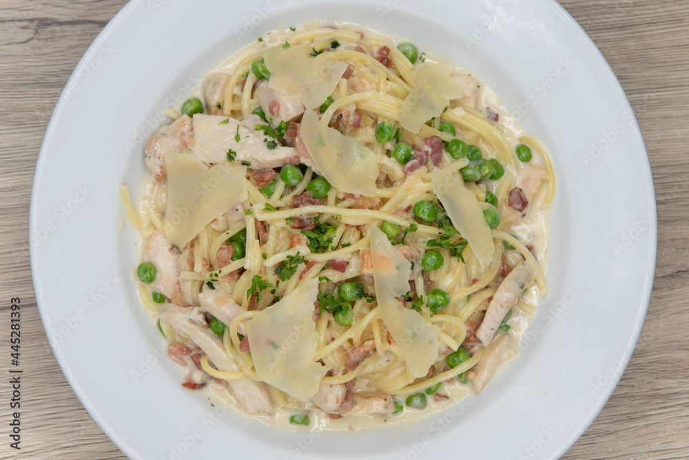 Overhead view of hearty bowl of chicken carbonara pasta made fresh and served hot for dinner