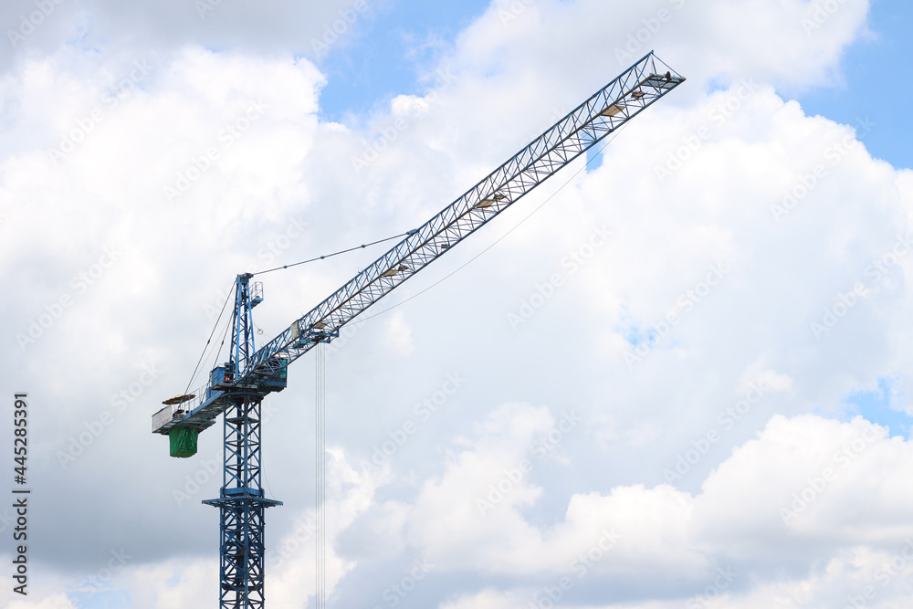 The construction crane on against blue sky. The construction crane on against blue sky.