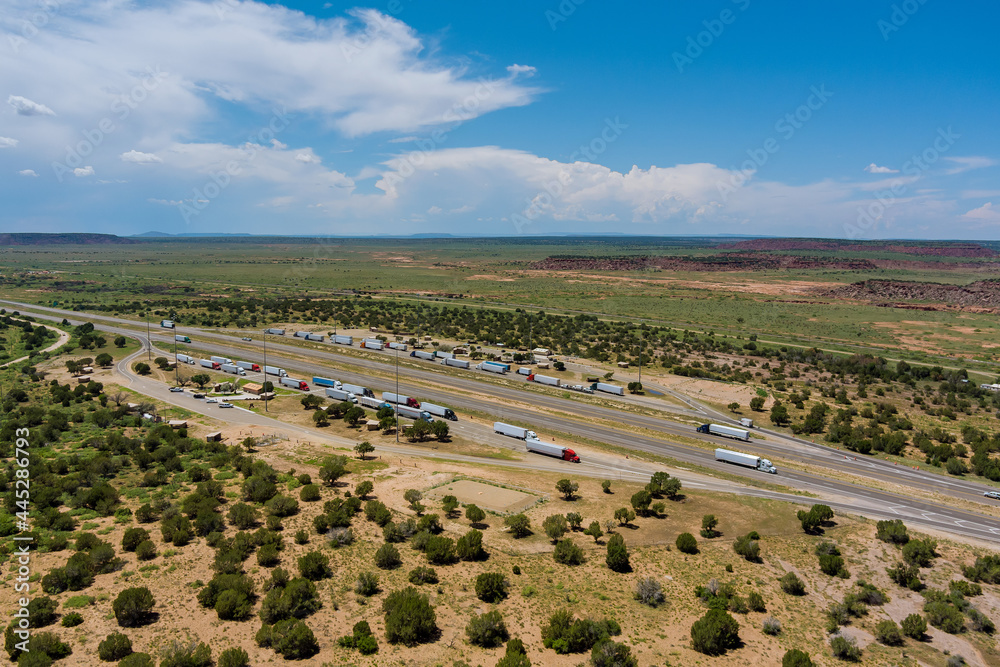 Obraz premium Aerial view of highway in desert Arizona of highway rest area with large car park for cars trucks