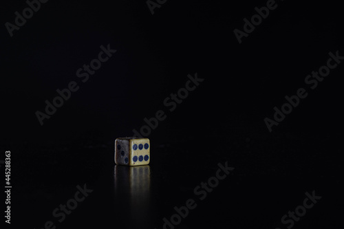 Photography dice number six on black background.