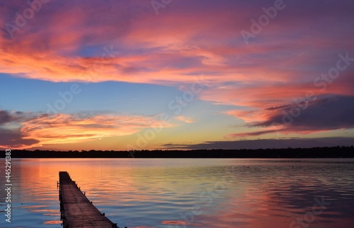 sunset on lake and pier