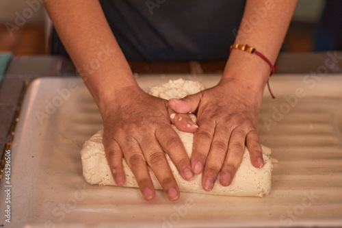 Woman kneading corn dough for homemade tortillas. Close-up