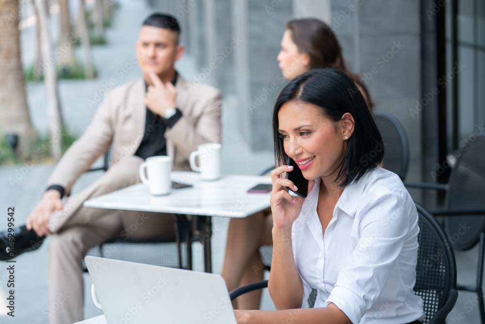 Young Business Woman Talking on Smartphone in Coffee Shop while Breaking time Young Business Woman Talking on Smartphone in Coffee Shop while Breaking time