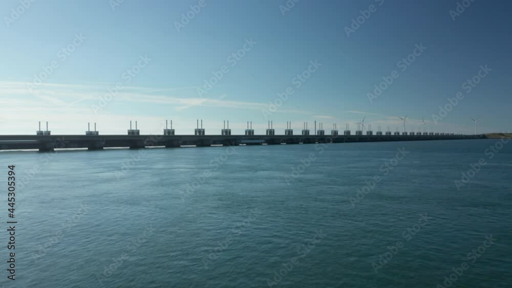 Aerial View Of Calm Waterscape Of Jacobahaven Canal And Spillway Gates Of Eastern Scheldt Storm Surge Barrier In Zeeland City, Netherlands. Aerial View Of Calm Waterscape Of Jacobahaven Canal And Spillway Gates Of Eastern Scheldt Storm Surge Barrier In Zeeland City, Netherlands.