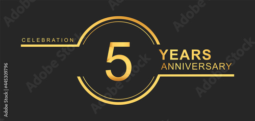 5th years anniversary golden and silver color with circle ring isolated on black background for anniversary celebration event photo