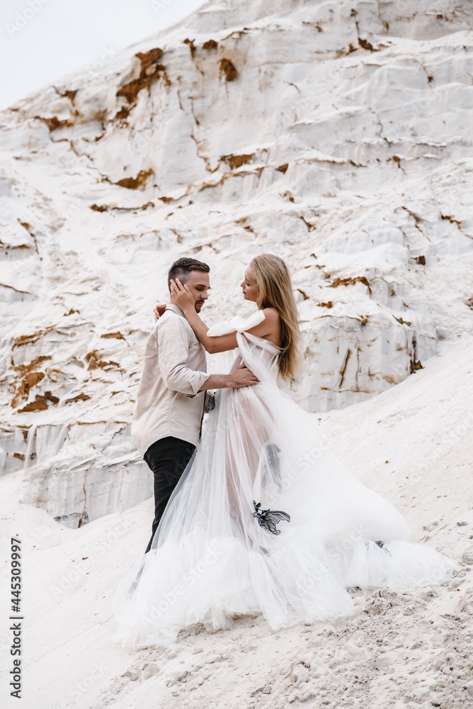 Beautiful wedding couple bride and groom at wedding day outdoors at ocean beach. Happy marriage couple o