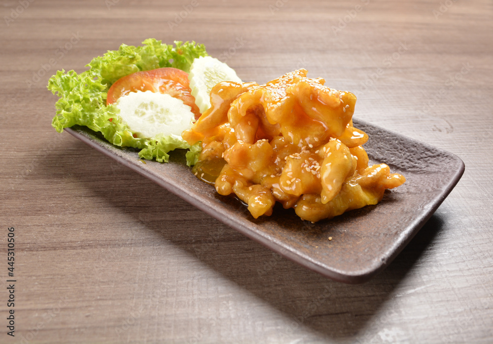 deep fried chicken with lemon sauce and sesame on wood background asian halal menu deep fried chicken with lemon sauce and sesame on wood background asian halal menu
