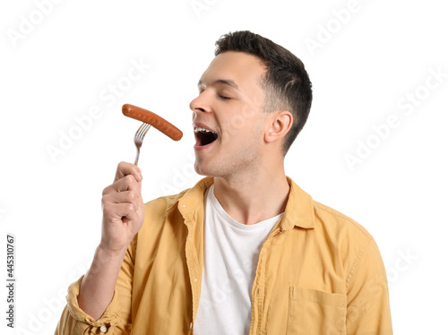 Young man eating tasty saus...