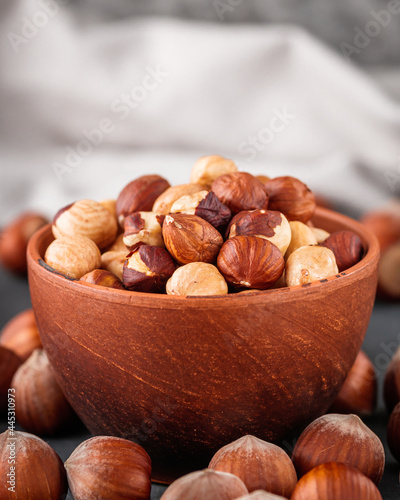 fresh natural hazelnuts on a dark stone background