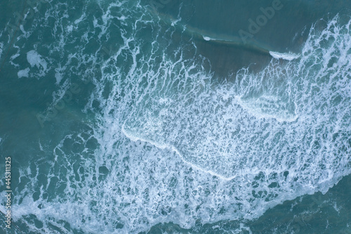 Sea wave running on a shallow coastal strip.