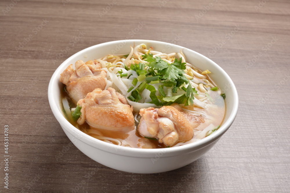 cook clear hot soup with chicken meat, vegetable and noodle on wood background asian halal menu cook clear hot soup with chicken meat, vegetable and noodle on wood background asian halal menu