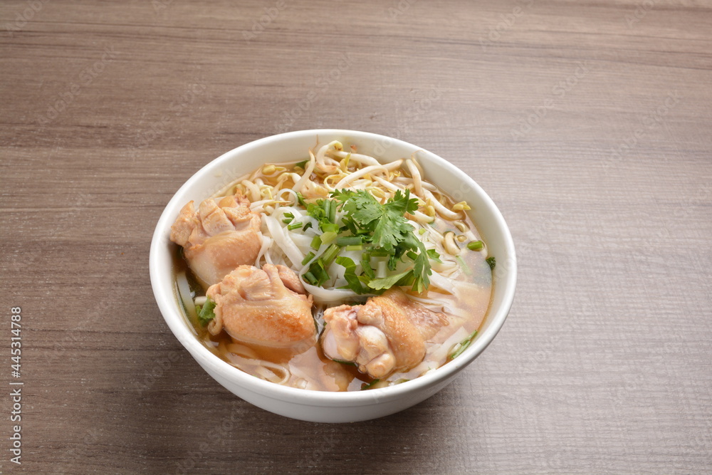 cook clear hot soup with chicken meat, vegetable and noodle on wood background asian halal menu cook clear hot soup with chicken meat, vegetable and noodle on wood background asian halal menu