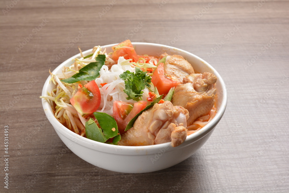 cook curry spicy chilli laksa soup with chicken meat, vegetable and noodle on wood background asian halal menu cook curry spicy chilli laksa soup with chicken meat, vegetable and noodle on wood background asian halal menu