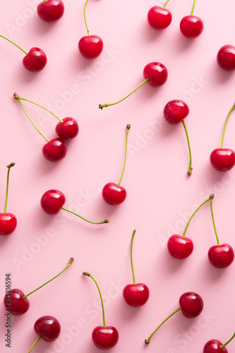 Wallpaper Mural Cherry pattern. Flat lay of cherries on pink background. Top view