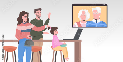 young family having virtual meeting with grandparents during video call chat online conference