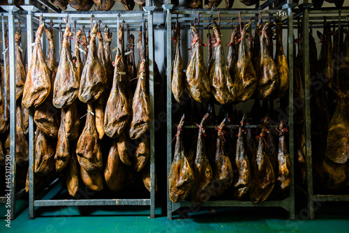 Obraz na plátně many Iberian Pata Negra hams hung ready to be sold in a warehouse